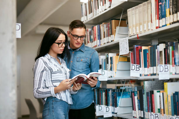 istock Couple Of Students In College Library 994185302