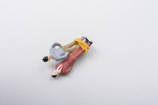istock Tiny figurine of men model  tied in rope 994195788