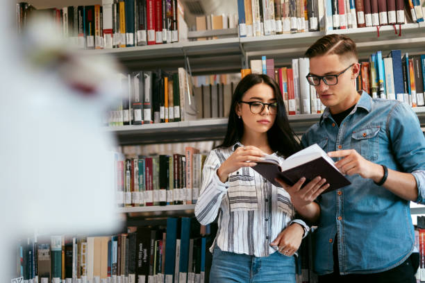 istock Couple Of Students In College Library 994198292