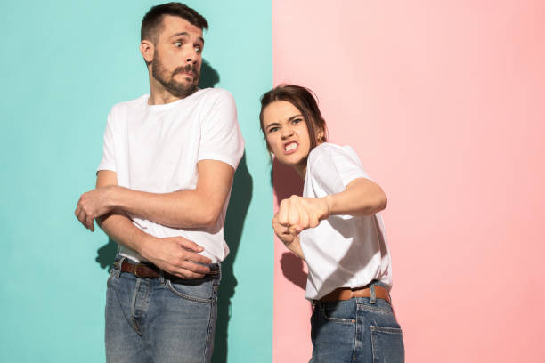 istock The young emotional angry woman on pink studio background 994214910