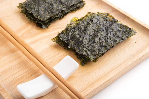 istock Crispy dried seaweed on wooden plate 994235632