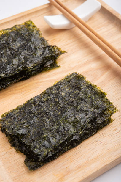 istock Crispy dried seaweed on wooden plate 994235660