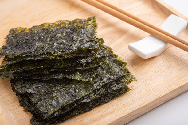 istock Crispy dried seaweed on wooden plate 994235756