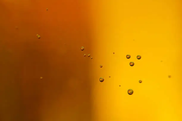Beautiful foam and bubbles in a glass of beer macro