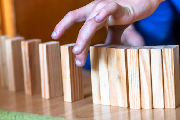 istock Boy playing with wooden blocks - ready to tilt 994246980