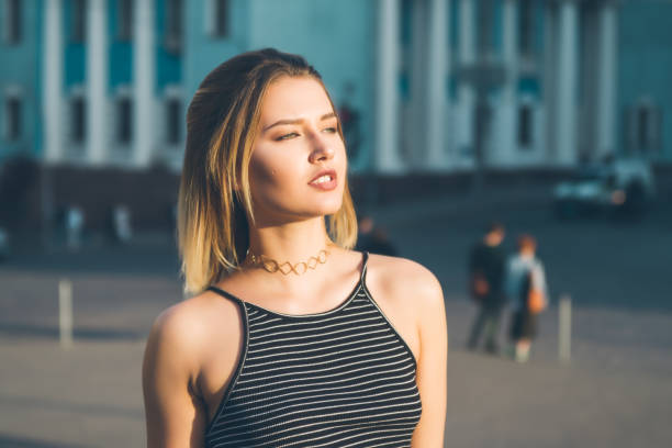 Portrait of a seductive girl,with blonde hair photographed in an urban contest, on a sunny day.