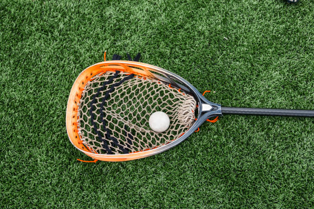 istock Orange and black goalie lacrosse stick 994255538