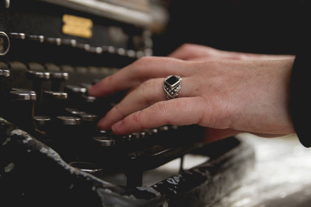 woman hands writing with an old typewriter - typewriter sepia toned old nostalgia imagens e fotografias de stock