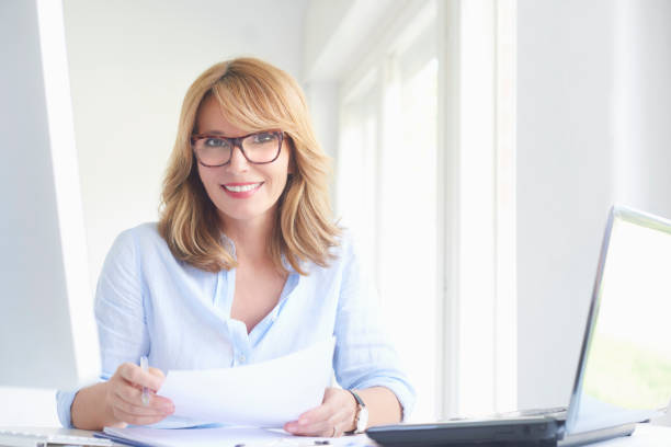 istock Happy mature businesswoman using laptop 994259286
