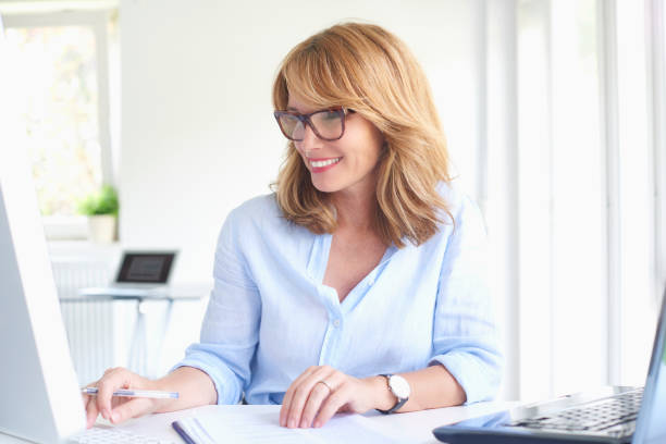 istock Happy mature businesswoman using computer 994259658