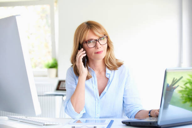 istock Successful businesswoman using her mobile phone at the office 994260006
