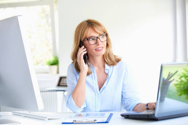 istock Successful businesswoman using her mobile phone at the office 994260066