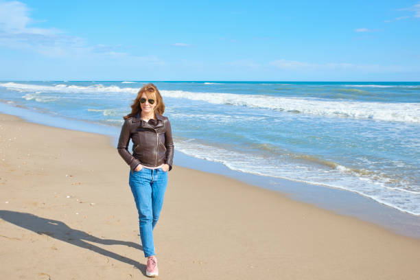 istock Woman walking at the beach 994263010
