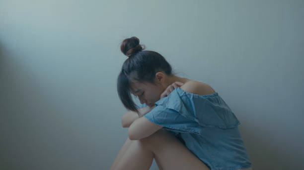 istock sad woman sitting alone in a empty room 994263154