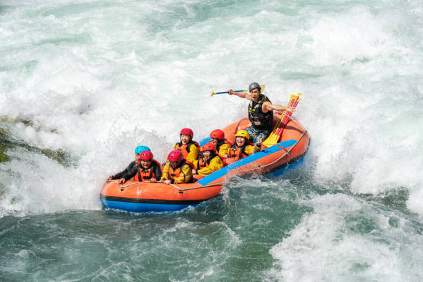 istock Small group of men and women white water river rafting 994263204
