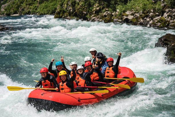 istock Group of nine men white water river rafting together 994263274
