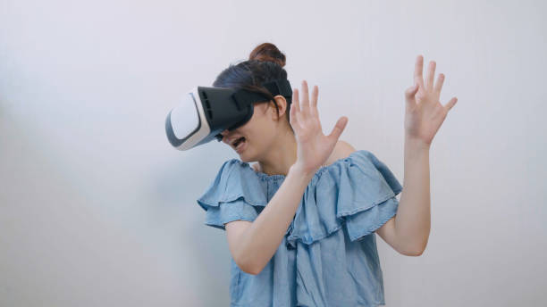 istock asian woman using the virtual reality headset 994263294