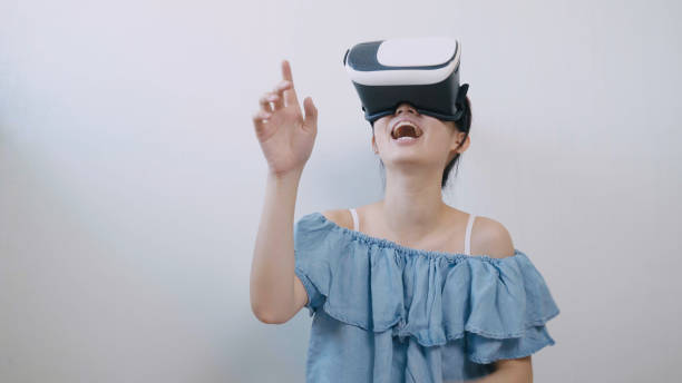 istock asian woman using the virtual reality headset 994263316