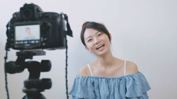istock Woman talking in front of the camera to make vlog 994263322