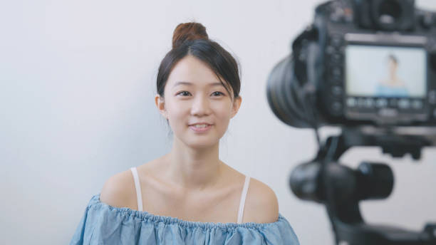 istock Woman talking in front of the camera to make vlog 994263328