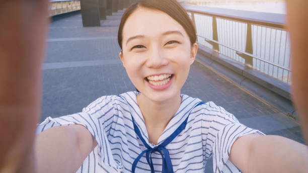 istock young woman smile take selfie 994263396