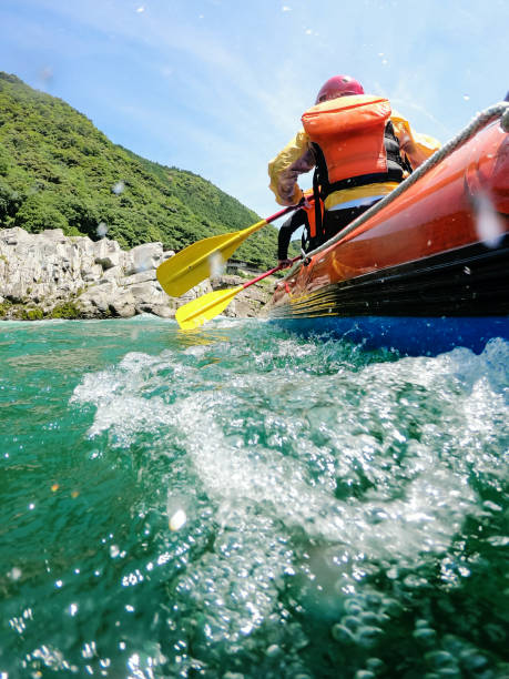 istock Low angle view of a white water river rafting excursion 994263748