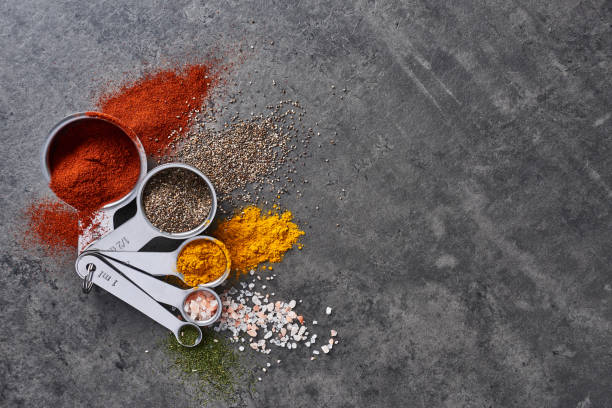 various spices in measuring cups. - measuring cup imagens e fotografias de stock