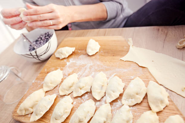 istock Woman is doing hand dumplings with blueberries 994267164