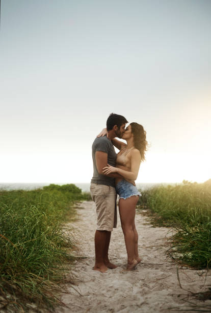 1,936 Young Couple Kissing At Sunset On Beach Stock Photos, Pictures &  Royalty-Free Images - iStock