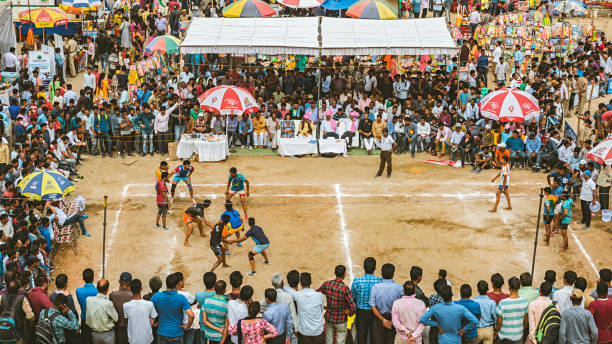 Kabaddi at Shoolini fair in Thodo ground, Solan, Himachal Pradesh. Solan, Himachal Pradesh, India - June 23, 2018: Young adult men play Kabaddi and huge crowed watch the game with great interest in Thodo ground at Shoolini fair which takes place every year in the last week of June. Shoolini fair is the largest and most respected public event of Solan, attracts tourists and local crowd. himachal pradesh photos stock pictures, royalty-free photos & images