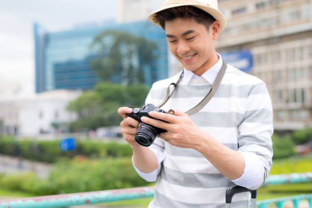 istock Attractive young man, student or freelance photographer smiles and laughs into camera 994272974