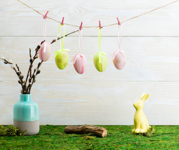 istock Easter hanging eggs over wooden background 994273146