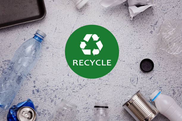 istock Eco concept with recycling symbol and garbage on table background top view 994273744