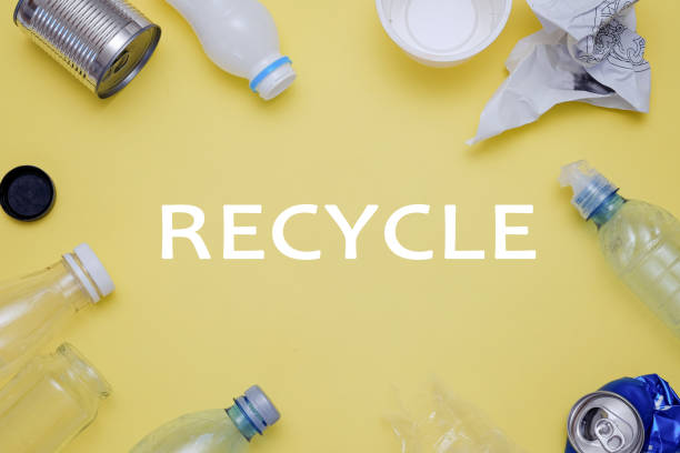 istock Eco concept with recycling symbol and garbage on table background top view 994274046