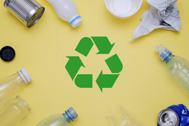 istock Eco concept with recycling symbol and garbage on table background top view 994274084
