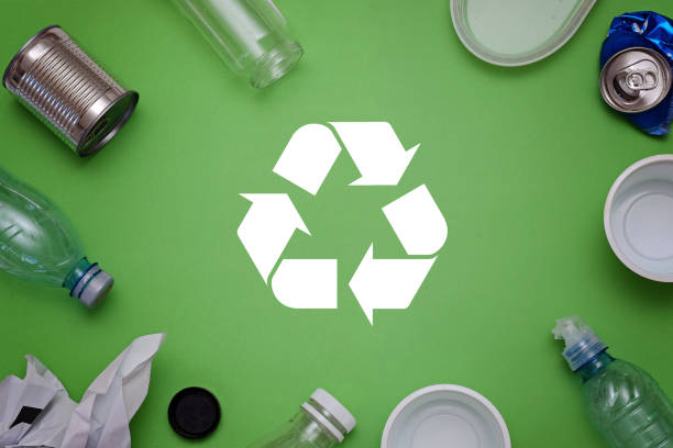 istock Eco concept with recycling symbol and garbage on table background top view 994274292