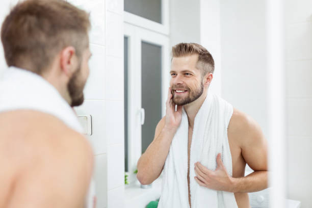 istock Morning hygiene, Man in the bathroom looking in mirror 994276666