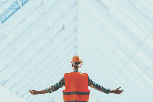 istock Standing Industrial Engineer in Vest and Helmet. 994284234