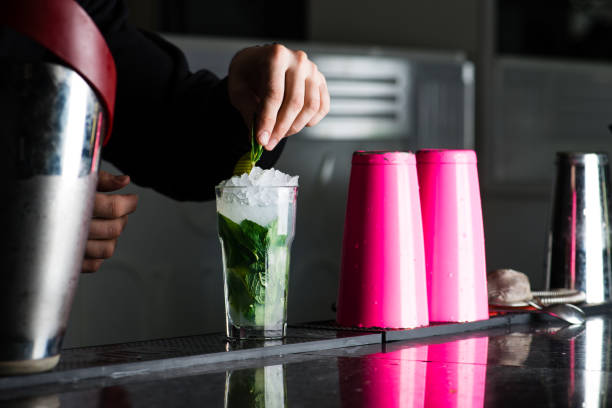 bartender in a nightclub pouring cocktail