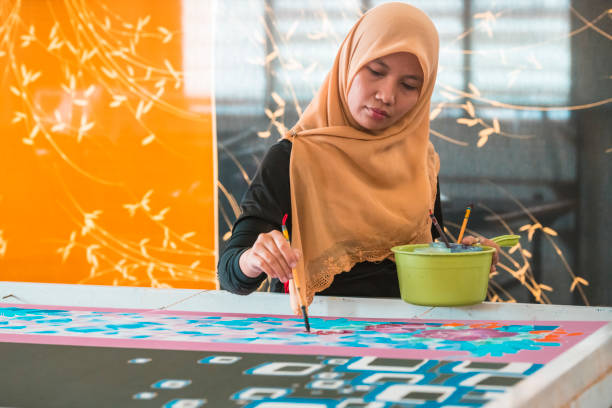 istock Woman painting in a batik workshop 994288142