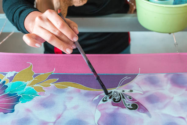 istock Woman painting in a batik workshop 994288164