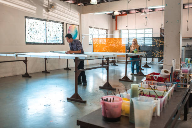 istock Coworkers painting in a batik workshop 994288188