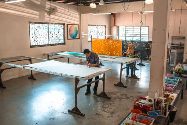 istock Coworkers painting in a batik workshop 994288196