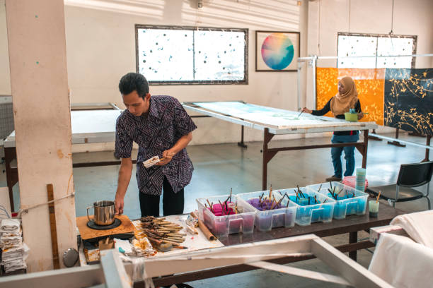 istock Coworkers painting in a batik workshop 994288198