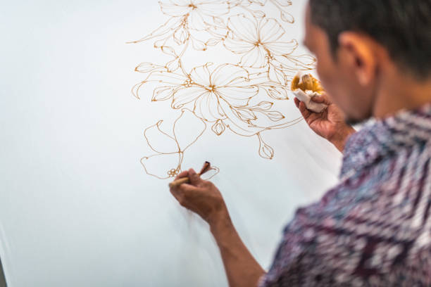 istock Man painting in a batik workshop 994288214