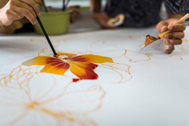 istock Coworkers painting in a batik workshop 994288322
