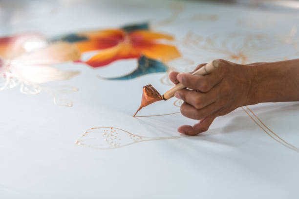 istock Woman painting in a batik workshop 994288328