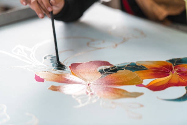istock Woman painting in a batik workshop 994288330