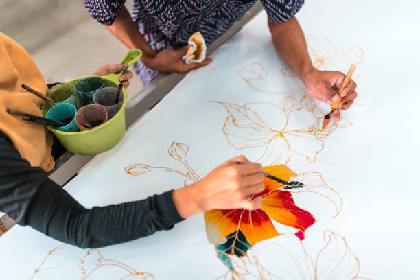 istock Coworkers painting in a batik workshop 994288346