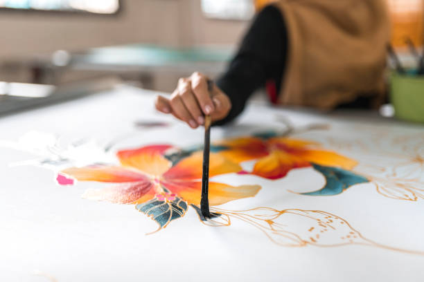 istock Woman painting in a batik workshop 994288352